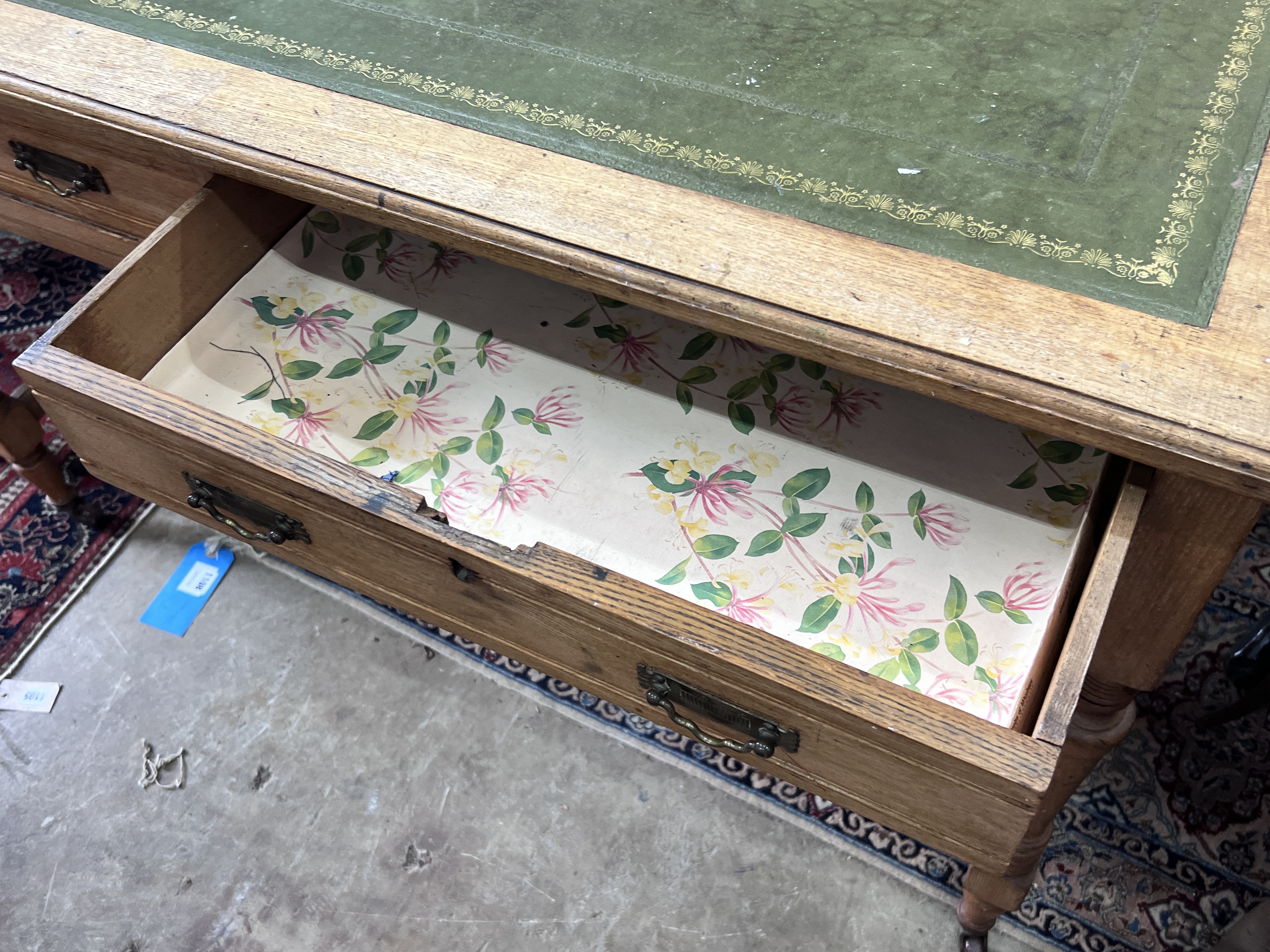 A late Victorian light oak two drawer writing table, width 120cm, depth 59cm, height 78cm